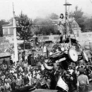 A woman standing on top of a vehicle