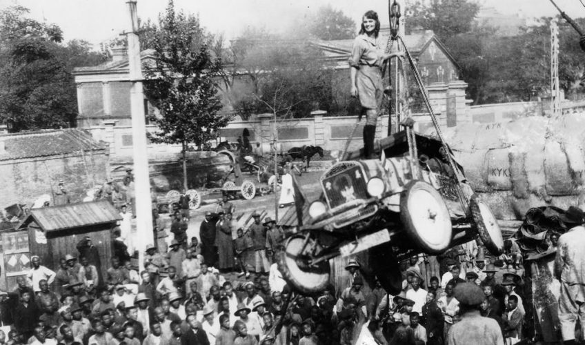 A woman standing on top of a vehicle